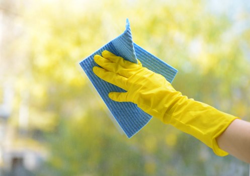 Tools used for effective window cleaning including squeegee and microfiber cloth